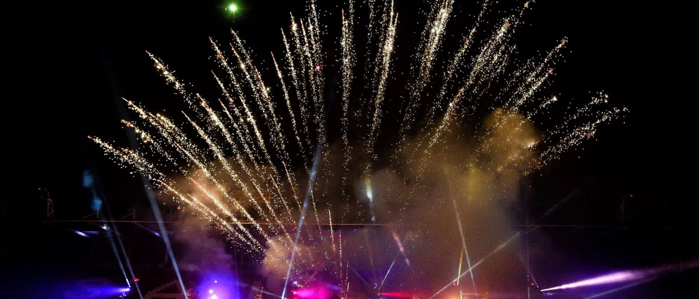 firework display with spotlights beaming underneath