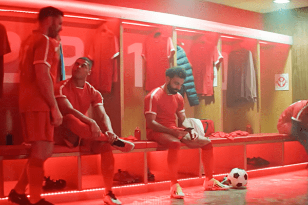 mo salah on a phone in a changing room