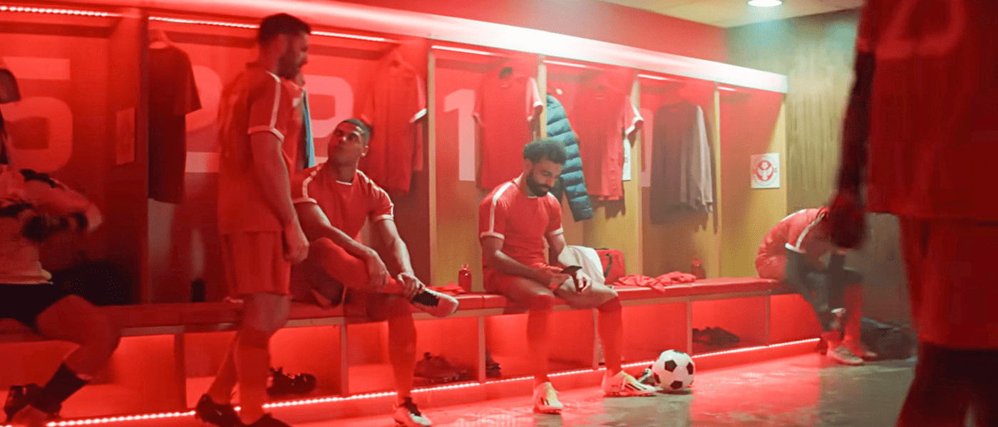mo salah on a phone in a changing room
