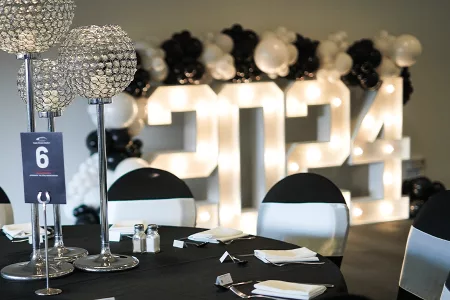 table with number 6 on it and 2024 sign in backdrop