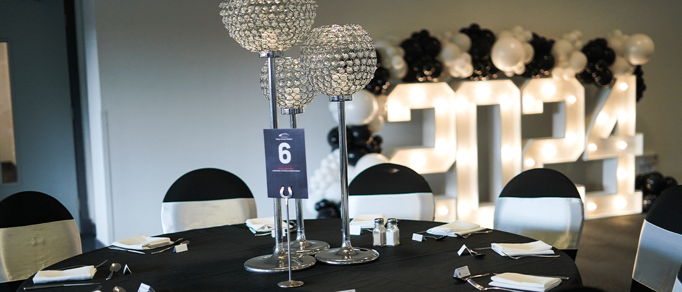 table with number 6 on it and 2024 sign in backdrop