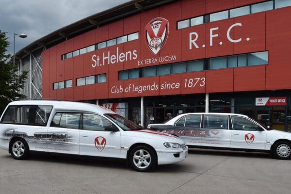 white funeral cars outside stadium