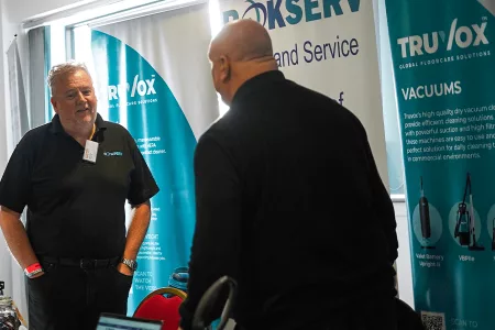 two men speaking to each other at an expo
