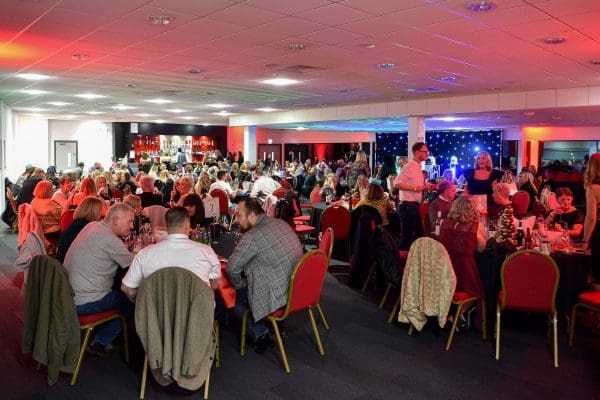 wide shot of people at event sat at tables